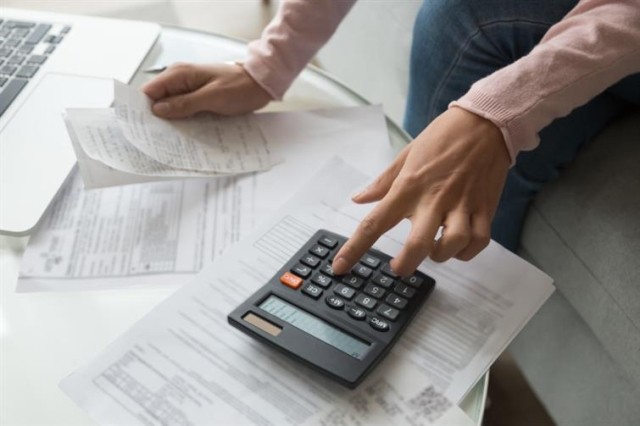 Renter with paperwork and a calculator