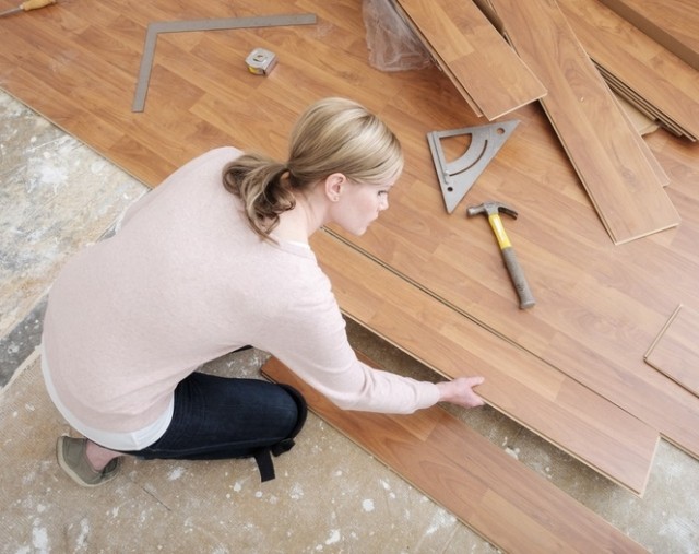 person installing laminate floor boards