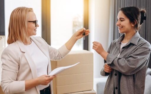 Landlord hands keys to their selected rental applicant. 