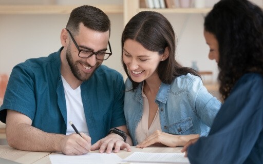 A young couple signs a lease with an independent landlord.