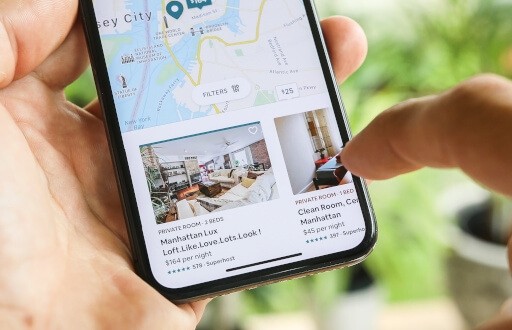 Renter scrolling on rental listing service.