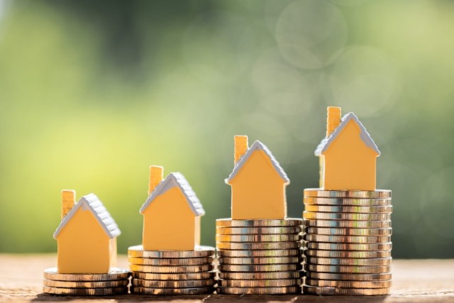 Diagram with houses sitting on top of money