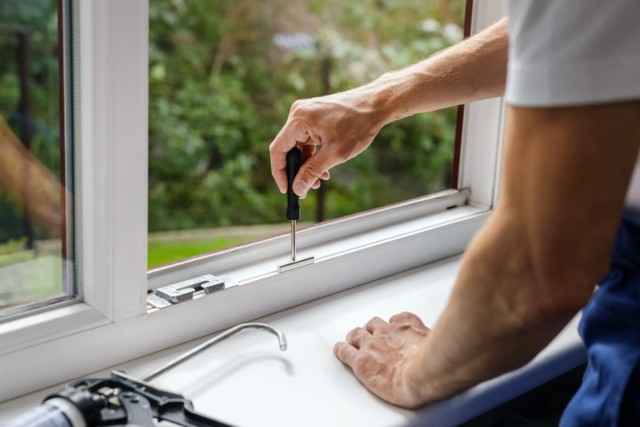 A Landlord Repairing a Windowsill
