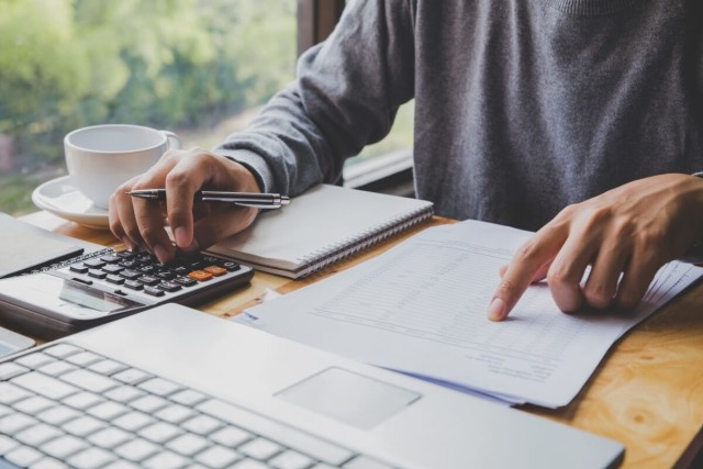 A landlord using a calculator