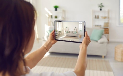 A landlord uses a tablet to capture a virtual tour of her rental property.