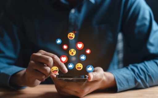 Man scrolls on social media platforms on his mobile device.