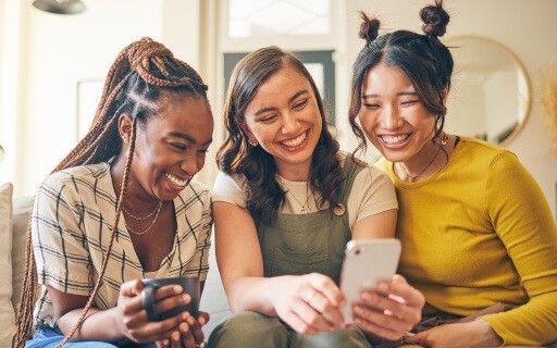 Gen Z renters watch funny social media content on their phones.