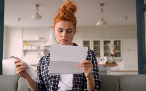 Tenant reads letter from her landlord.