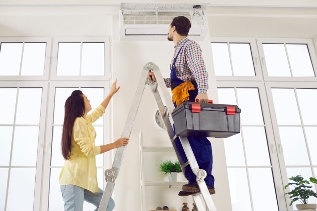 A tenant speaking with a repair man in her apartment