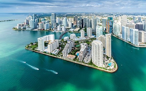 The Miami skyline rises over the water.