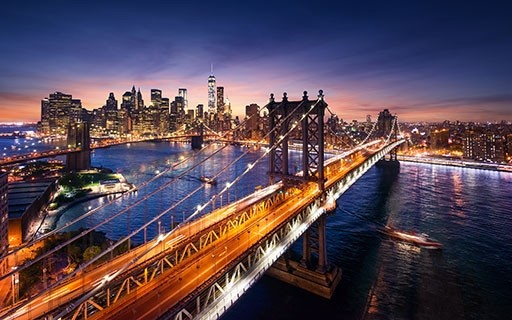 Bridges over the Hudson River leading to New York shine in the evening.