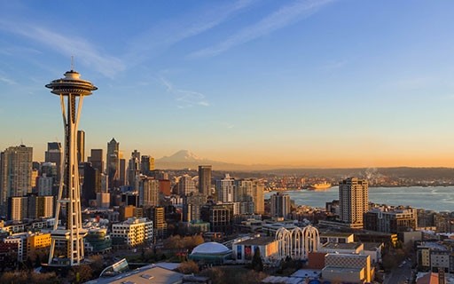 The Space Needle rises above Seattle in the morning light.