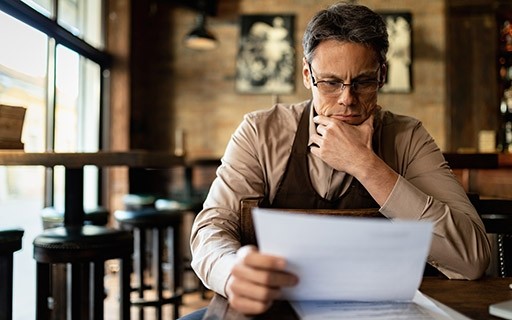Man reading over papers by himself.