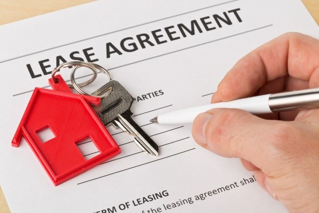 A lease agreement document being signed