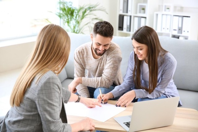 A couple signing a lease in their new condo