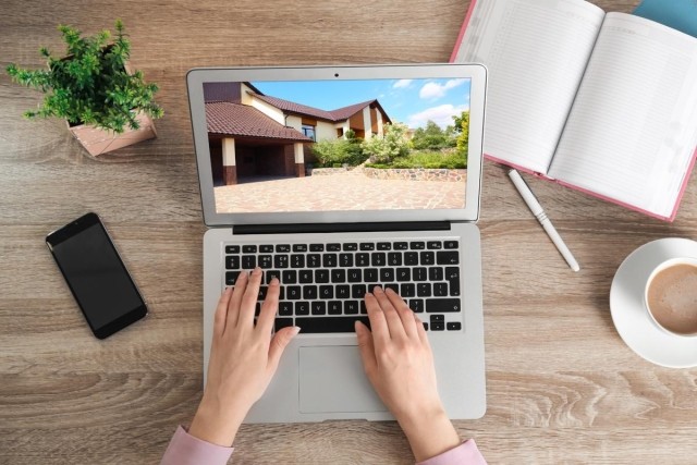 A person creating a rental listing on a laptop