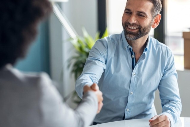 A landlord shaking the hand of someone